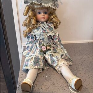 Vintage Porcelain Doll 16in with blond curls and blue floral dress